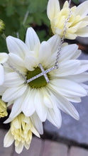 Sideways cross on flower
